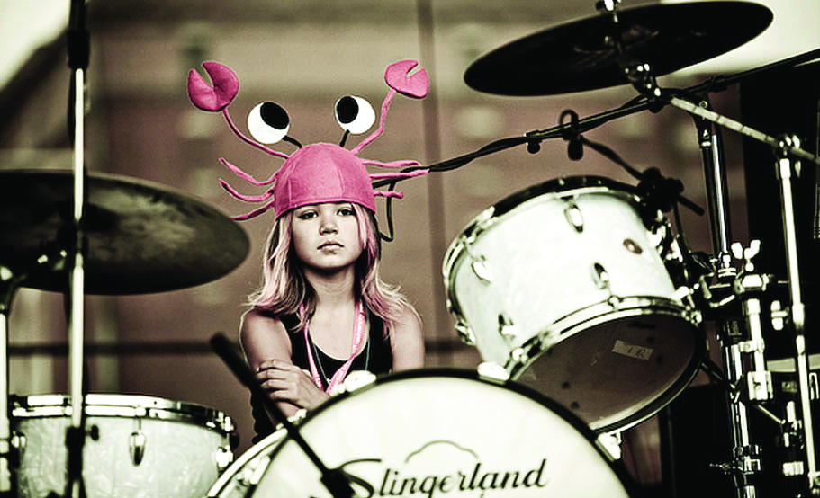 Girl at drum set with sassy hat