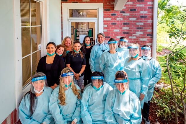 Dental staff wearing protective clothing