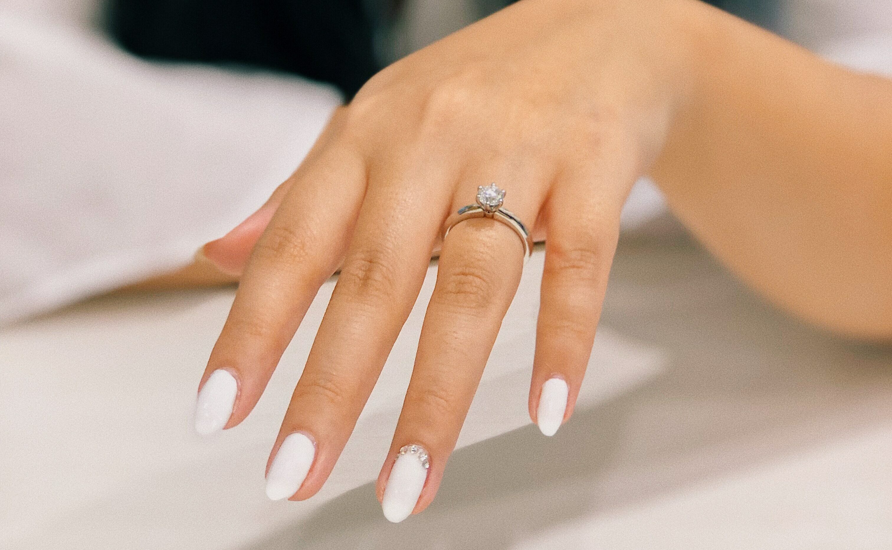 Smooth hand with fresh manicure and engagement ring