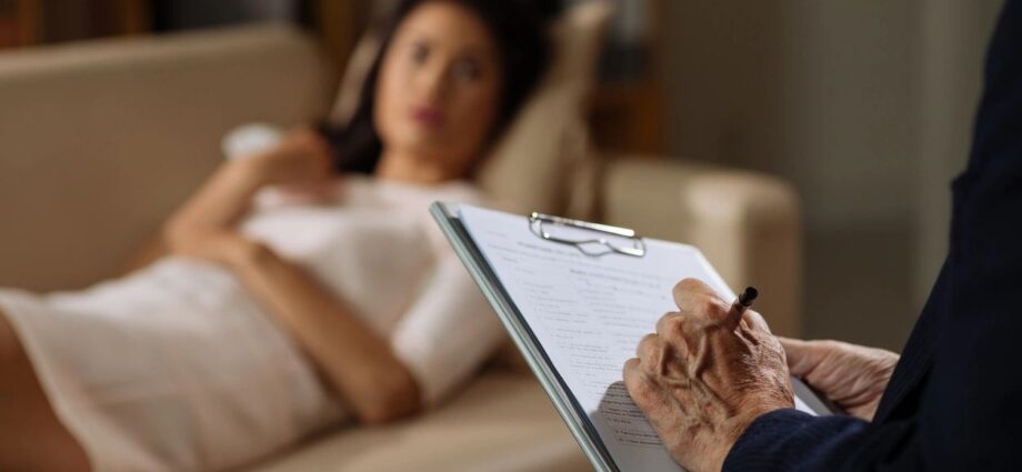 woman on couch with person taking notes